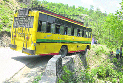 A bus perched precariously after its driver lost control over it on the Katra-Reasi road on Monday.
