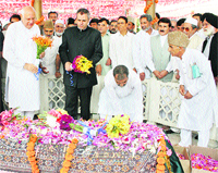 Union Minister for New and Renewable Energy Farooq Abdullah and Chief Minister Omar Abdullah pay floral tributes to Begum Akbar Jahan at her grave in Srinagar on Monday.