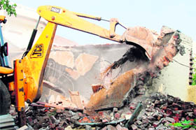 Razes illegal rooms constructed in a park near Sunet village on Monday.