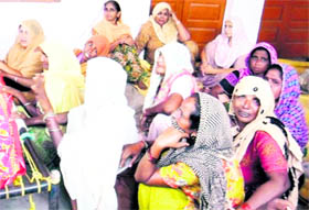 Grief-stricken family members of the woman who died at Cheemna village near Jagraon on Monday.
