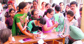 Students throng a college as the admission process began in Ludhiana on Monday.