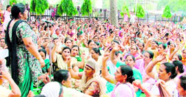 Aanganwadi workers protest outside the mini-secretariat in Ludhiana on Monday.