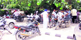 In the absence of proper seating arrangement, visitors have to sit under the shade of trees.