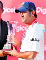 MS Dhoni with the winners trophy in Dominica on Sunday.