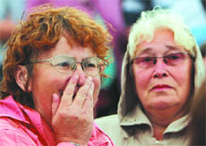 A woman reacts as she meets survivors from the Bulgaria tourist boat, which sank on the Volga river, at the port of Kazan on Sunday.