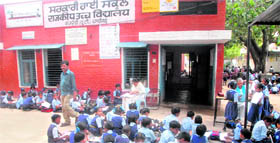 Schoolchildren sitting in the scorching sun without mattress at Government High School, Kajheri, Chandigarh.