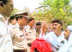 Residents of Patel Nagar carrying the ashes of a murdered juice vendor hand over a memorandum to ADC Ashok Garg (left) and SP Hanif Qureshi (centre) in Hisar