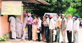People wait at the Civil Surgeons office for birth/death certificates in Ludhiana 