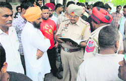 Relatives of a patient protest outside a nursing home in Ludhiana 