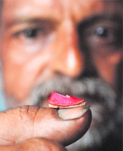 A Patiala craftsman, Guru Dutt, shows worlds smallest Punjabi jutti.