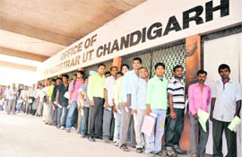 People queue for attestion of documents at the sub-registrars office at Sector 17 in Chandigarh. 