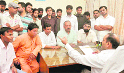 Youth Congress workers submit a memorandum to secretary of the Mussoorie-Dehradun Development Authority Vinod Suman in Dehradun on Wednesday. 