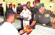 The Army chief, Gen VK Singh, offers a fruit hamper to an ailing jawan after the former formally opened the 250-bedded multi-speciality Military Hospital at Hisar on Wednesday. 