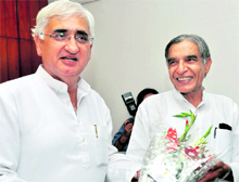 Union Minister for Parliamentary Affairs Pawan Kumar Bansal (right) being greeted by new Union Law Minister Salman Khursheed. Bansal assumed additional charge of the Water Resources Ministry in New Delhi on Wednesday