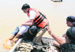 A volunteer of the flood rescue team from Patiala rehearses an emergency rescue at the Sukhna lake in Chandigarh on Thursday