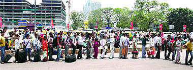 Passengers queue up outside the New Delhi railway station to get their baggage screened after the Mumbai serial blasts on Thursday.