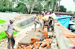 Labourers repair newly built stairs in the Pavillion grounds in Dehradun