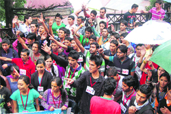 SFI activists raise slogans outside the DC office in Shimla on Thursday. 