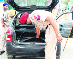 Policemen inspect a vehicle in Amritsar 