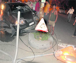 The mangled remains of a car that rammed into an electricity pole. 
