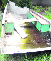 A broken boat to be used during floods lying defunct in a village. 