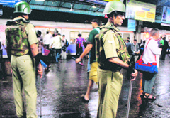 Security personnel deployed at the Thane railway station after high alert was sounded following serial blasts in Mumbai. 