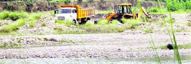 A tipper ferrying sand at Chak-Meerpur village in Hoshiarpur. 