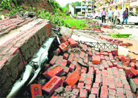  A parked Maruti Wagon R buried under debris of a collapsed wall near VIP road at Zirakpur on Friday