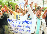 Shopkeepers of Lambian village protest against GMADA at Phase VIII in Mohali on Friday. 