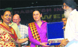 Chief Minister Parkash Singh Badal presents a memento to Dr Maria (Macuy) Haberfield of John Jay College of Criminal Justice, New York, at Badal village on Friday.