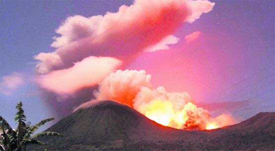 The glow of lava from Mount Lokon is seen against the night sky from Tomohon, Indonesia, on Thursday. Residents were evacuated after the volcano erupted, spewing hot ash and sending lava cascading down the mountain slopes