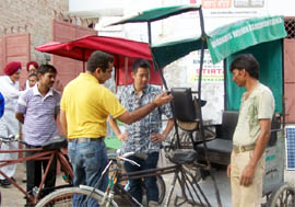 GWAF general secretary Navdeep Asija showing the latest model of the eco-cab to MIT scholar Alber Ching in Fazilka 