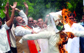 Activists of the Rashtrawadi Shiv Sena burn an effigy of a terrorist during a demonstration against Afzal Guru and Kasab involved in the earlier terror attacks, demanding to hang them till death in New Delhi on Saturday.