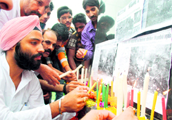 Members of the Kranti Dal pay homage to the victims of the Mumbai serial blasts, in Jammu on Saturday