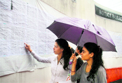 Students look for their names on the notice board on the first day of the academic session at Government College for Women, Parade, in Jammu on Saturday