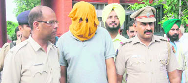 The accused, Gurmeet Singh Gill, in police custody in Chandigarh 