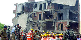 Members of the Army rescue team and National Disaster Relief Force remove debris of the building in search of bodies at Shalimar Garden in Ghaziabad on Sunday. 