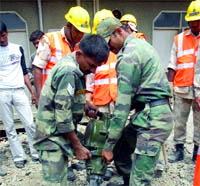 Members of the Army rescue team and National Disaster Relief Force remove debris of the building in search of bodies at Shalimar Garden in Ghaziabad on Sunday. 