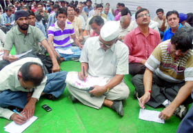 People register their name for the volunteers of the lokpal to come forward for the fight against corruption at Jantar Mantar in New Delhi on Sunday.