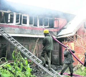 Fire Brigade personnel try to control a fire, which broke out at Wazir Bagh in Srinagar 