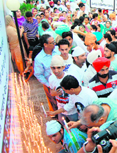 Residents light candles on the birth anniversary of murdered hotelier Gurkirat Singh Sekhon (Gikki) in Jalandhar on Sunday