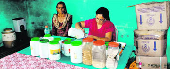 A one-room dispensary with medicines stored in cartons and a small kitchen in the corner at Gabhlawaas, Morni.  