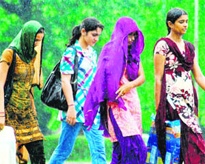 Students walk in the rain at Panjab University, Sector 14, Chandigarh