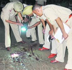 The police inspects the site of the shootout at Mauli Jagran in Chandigarh 