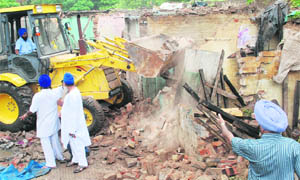 A GMADA team undertakes a demolition drive at Lambian village in Mohali
