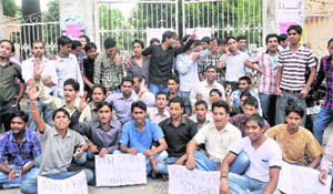Students stage a dharna after locking the gate of  DAV (PG) College on the first day of the new academic session in Dehradun 