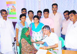 A cardiologist examines a patient at a free medical camp at Baiyanpur village in Sonepat district on Sunday. 