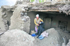 Yang Chan Dolma shows the torn clothes that were sent by an NGO.