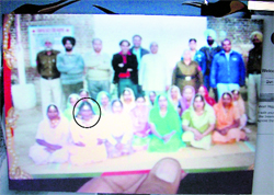 A UHRO activist shows the footage of Subhash (encircled) in a womans jail