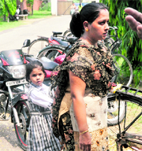 A woman along with her child await her turn for getting unique IDs